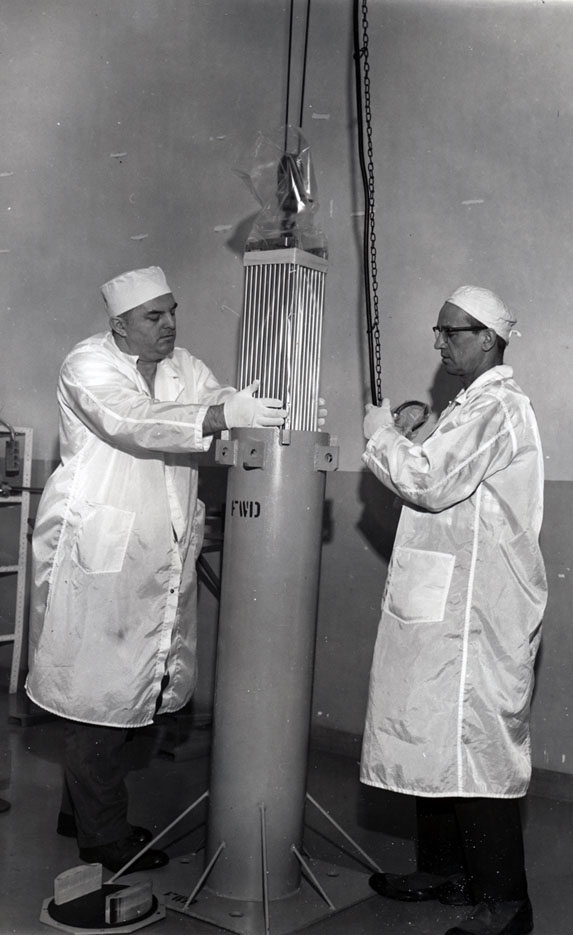 two technicians loading fuel rod assembly